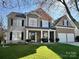 Charming two-story home with a well-manicured lawn, inviting front porch and a brick and siding facade at 114 Runningdeer Dr, Mooresville, NC 28117