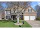 Traditional two-story home featuring a two-car garage, front lawn, and neutral-tone facade at 114 Runningdeer Dr, Mooresville, NC 28117