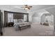 Spacious main bedroom with tray ceiling, wood accent wall, and carpet flooring at 114 Runningdeer Dr, Mooresville, NC 28117