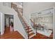 Elegant staircase with wood treads, black iron spindles, and views into the dining room at 114 Runningdeer Dr, Mooresville, NC 28117