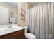 Full bathroom with shower and vanity with framed pictures on the wall at 12031 Windy Rock Way # 1002, Charlotte, NC 28273