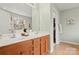 Bathroom featuring double sinks and a bright window, leading to a walk-in closet at 12031 Windy Rock Way # 1002, Charlotte, NC 28273