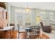 Bright dining area featuring a glass table, with an accent wall unit and a large sliding glass door at 12031 Windy Rock Way # 1002, Charlotte, NC 28273