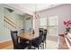 Bright dining space with classic chandelier, neutral walls, and dark wood table set for comfortable dining at 12031 Windy Rock Way # 1002, Charlotte, NC 28273