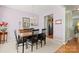 Elegant dining area with a chandelier, neutral walls, and dark wood table set for formal gatherings at 12031 Windy Rock Way # 1002, Charlotte, NC 28273