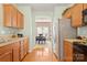 Functional kitchen featuring wood cabinets, stainless steel appliances, and a view into the adjacent dining area at 12031 Windy Rock Way # 1002, Charlotte, NC 28273