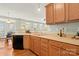 Extended view of the kitchen and dining space featuring wood cabinets and views of the bright windows at 12031 Windy Rock Way # 1002, Charlotte, NC 28273