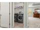 Convenient laundry room with washer and dryer, shelving and storage space at 12031 Windy Rock Way # 1002, Charlotte, NC 28273