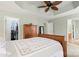 Light-filled main bedroom with wooden furniture, leading to a walk-in closet and bathroom at 12031 Windy Rock Way # 1002, Charlotte, NC 28273