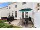 Outdoor patio features a table with chairs, grill and lush green lawn at 12031 Windy Rock Way # 1002, Charlotte, NC 28273