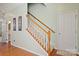 Stairway with wood railing leading to the second level, located next to a hallway doorway at 12031 Windy Rock Way # 1002, Charlotte, NC 28273