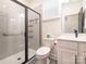 A modern bathroom with a glass-enclosed shower, white vanity, and stylish floor tiles at 12234 Rowan Hill Dr, Huntersville, NC 28078