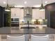 This modern kitchen is complete with an island with seating and stylish pendant lighting at 12234 Rowan Hill Dr, Huntersville, NC 28078