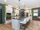 Modern kitchen featuring a large island, pendant lighting, stainless steel appliances, and stylish white cabinets at 12234 Rowan Hill Dr, Huntersville, NC 28078