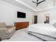 Bright main bedroom featuring a sleek ceiling fan, dresser, and comfortable seating area at 12234 Rowan Hill Dr, Huntersville, NC 28078