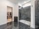 Modern shower featuring a marble surround, glass door, and access to the closet at 12234 Rowan Hill Dr, Huntersville, NC 28078