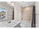 Clean bathroom with a tub, shower, and view to the outdoors at 13108 Brooklyn Skylar Way, Huntersville, NC 28078