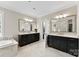 Bright bathroom with marble floors, large vanity mirrors, and stylish white and dark cabinets at 13108 Brooklyn Skylar Way, Huntersville, NC 28078