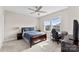 Cozy bedroom featuring a comfortable bed, a large window, and a functional workspace at 13108 Brooklyn Skylar Way, Huntersville, NC 28078