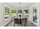 Charming dining room with a round table and a bay window with views of the backyard at 13108 Brooklyn Skylar Way, Huntersville, NC 28078