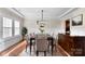 Formal dining room featuring a chandelier, wainscoting, and a large table at 13108 Brooklyn Skylar Way, Huntersville, NC 28078