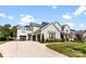 Charming two-story home with a three-car garage and well-manicured lawn at 13108 Brooklyn Skylar Way, Huntersville, NC 28078