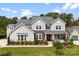 Attractive two-story home featuring a landscaped yard, stone accents and welcoming front porch at 13108 Brooklyn Skylar Way, Huntersville, NC 28078