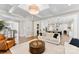 Inviting living room with coffered ceilings, fireplace, and open layout to kitchen and dining spaces at 13108 Brooklyn Skylar Way, Huntersville, NC 28078