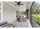 Relaxing screened-in porch with a stone fireplace, ceiling fan, and patio table with seating at 13108 Brooklyn Skylar Way, Huntersville, NC 28078