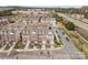 Aerial shot of townhomes featuring garages and street parking with a community school in the background at 14139 Winford Ln, Charlotte, NC 28262