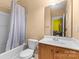 Cozy bathroom with a shower-tub combination, sleek vanity, and ample lighting in this home at 14139 Winford Ln, Charlotte, NC 28262