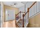 Welcoming foyer featuring hardwood floors and a staircase leading to the upper level of the home at 14139 Winford Ln, Charlotte, NC 28262