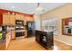 Stylish kitchen featuring stainless steel appliances, a central island, and hardwood flooring at 14139 Winford Ln, Charlotte, NC 28262