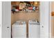 Functional laundry room boasts a washer, dryer, and storage shelves to keep essentials organized at 14139 Winford Ln, Charlotte, NC 28262