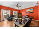 Inviting living room with hardwood floors, ceiling fan, and sliding glass doors to a wooden deck at 14139 Winford Ln, Charlotte, NC 28262