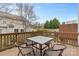 Outdoor patio area with wooden deck overlooking neighborhood with table and four chairs at 14139 Winford Ln, Charlotte, NC 28262