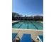 Community swimming pool with clear blue water, lounge chairs, and a covered pool house at 14139 Winford Ln, Charlotte, NC 28262