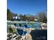 Inviting community pool with blue lounge chairs and a striped umbrella for shade at 14139 Winford Ln, Charlotte, NC 28262