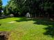 Large green backyard with mature trees and a shed at the back for storing lawn equipment and tools at 14922 Rolling Sky Dr, Charlotte, NC 28273