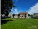 Expansive backyard with lush green grass and a charming white picket fence lining the in-ground pool area at 14922 Rolling Sky Dr, Charlotte, NC 28273