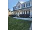 Inviting two-story home featuring a classic facade, covered front porch and neatly landscaped yard at 14922 Rolling Sky Dr, Charlotte, NC 28273