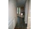 Hallway with tiled floor, and decorative trim, providing an inviting transition to the kitchen space at 14922 Rolling Sky Dr, Charlotte, NC 28273