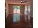 Spacious living room with hardwood flooring, fireplace, sliding glass door access to backyard, and backyard view at 14922 Rolling Sky Dr, Charlotte, NC 28273