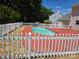 Relax by the pool with a spacious patio and a white picket fence at 14922 Rolling Sky Dr, Charlotte, NC 28273