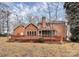 Brick house with a large wooden deck, screened in porch, and spacious well maintained backyard at 1531 Wheaton Nw Way, Concord, NC 28027