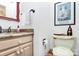 Traditional bathroom with granite countertop, mirror, decorative towels, and toilet with decorative cover at 1531 Wheaton Nw Way, Concord, NC 28027