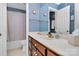 Bathroom featuring a vanity with brown cabinets, a white sink and a shower/tub combo at 1531 Wheaton Nw Way, Concord, NC 28027