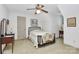 Bright bedroom featuring a ceiling fan, neutral walls, and a comfortable bed with a decorative quilt at 1531 Wheaton Nw Way, Concord, NC 28027