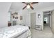 Well-lit bedroom with neutral walls, comfortable bed, and a unique decorative shelf with hanging bags at 1531 Wheaton Nw Way, Concord, NC 28027