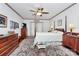 Bedroom featuring a four-poster bed, ceiling fan, wooden furniture, and a decorative rug at 1531 Wheaton Nw Way, Concord, NC 28027